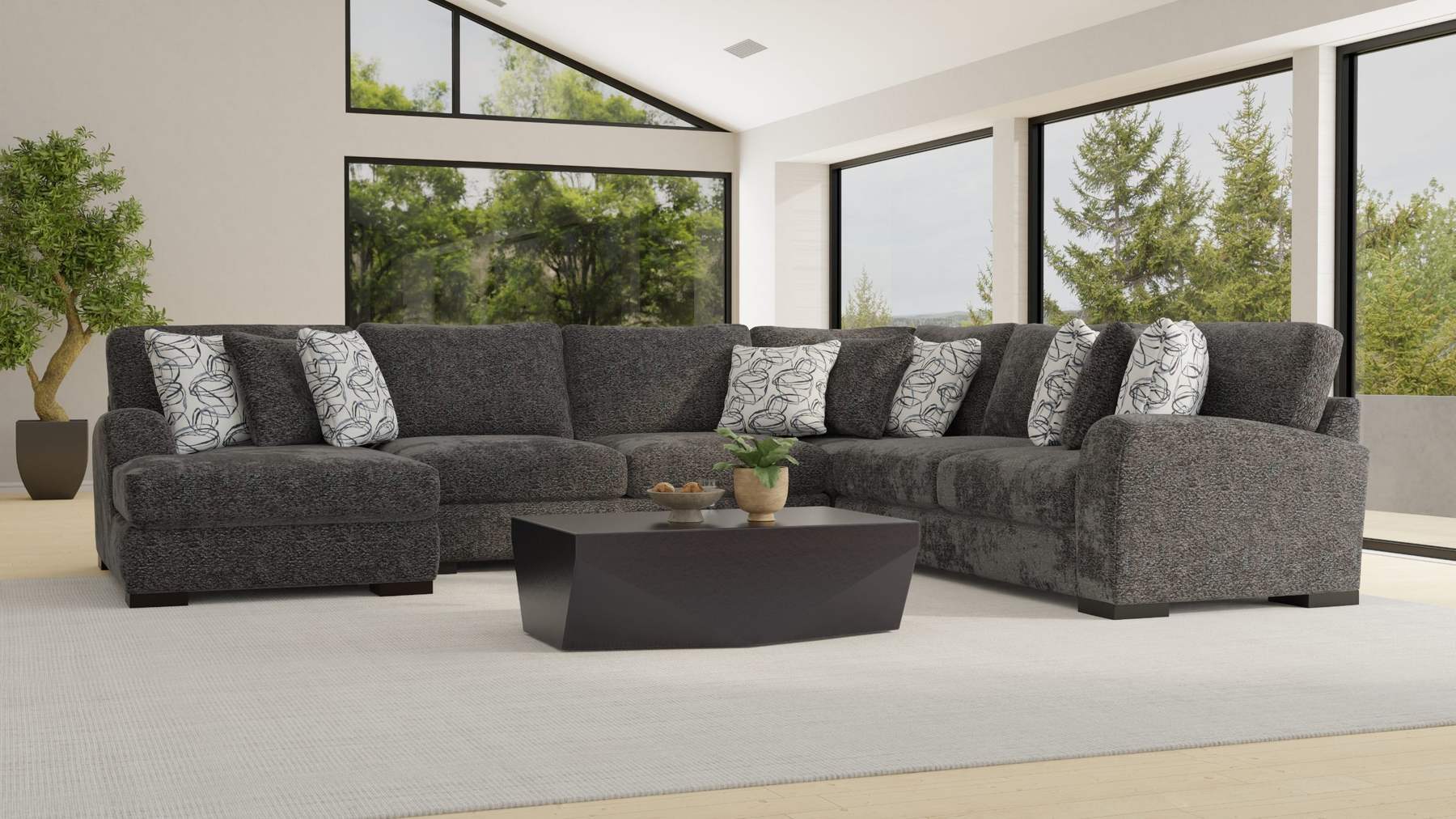 Charcoal sectional in a bright room with tall windows